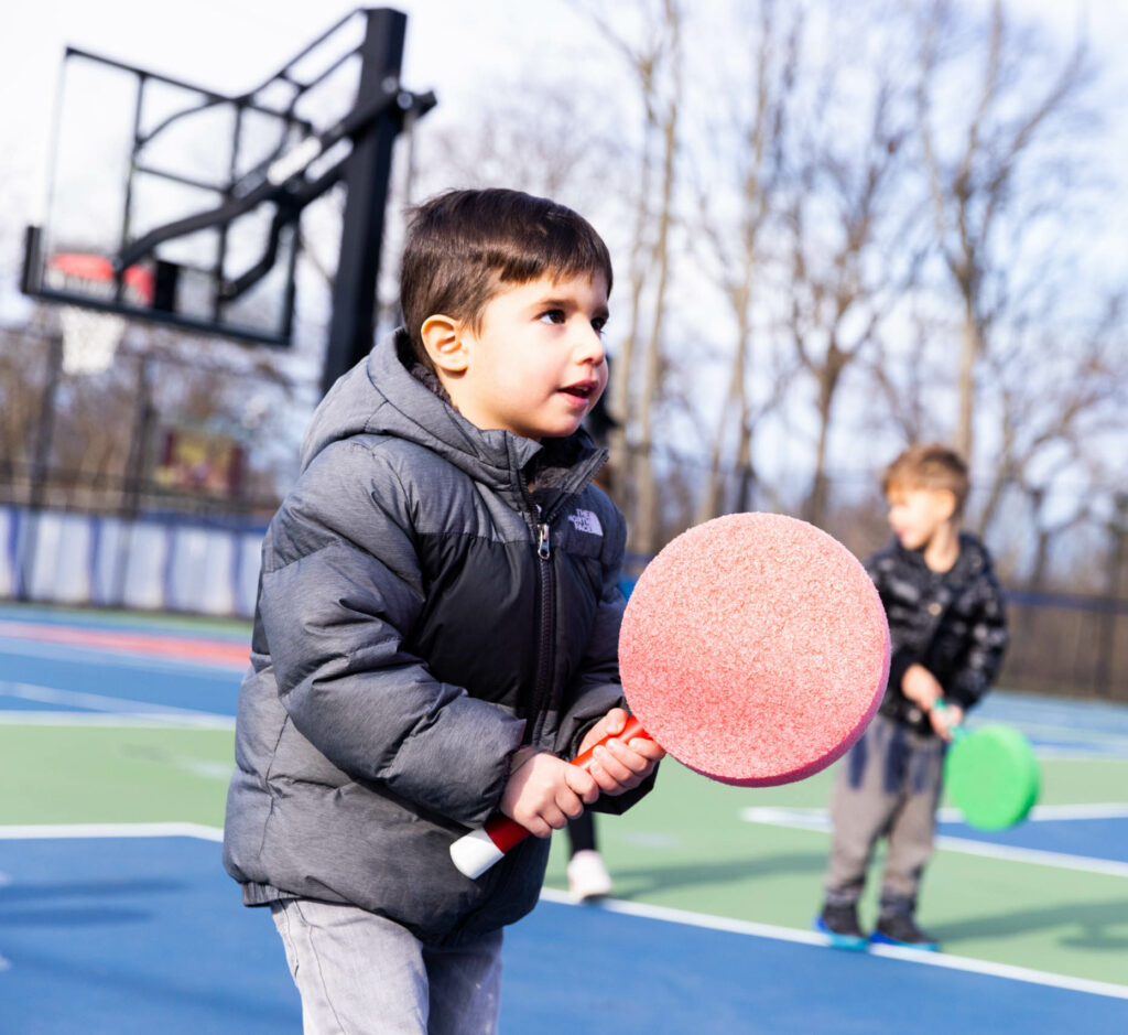 Children on tennis courts.